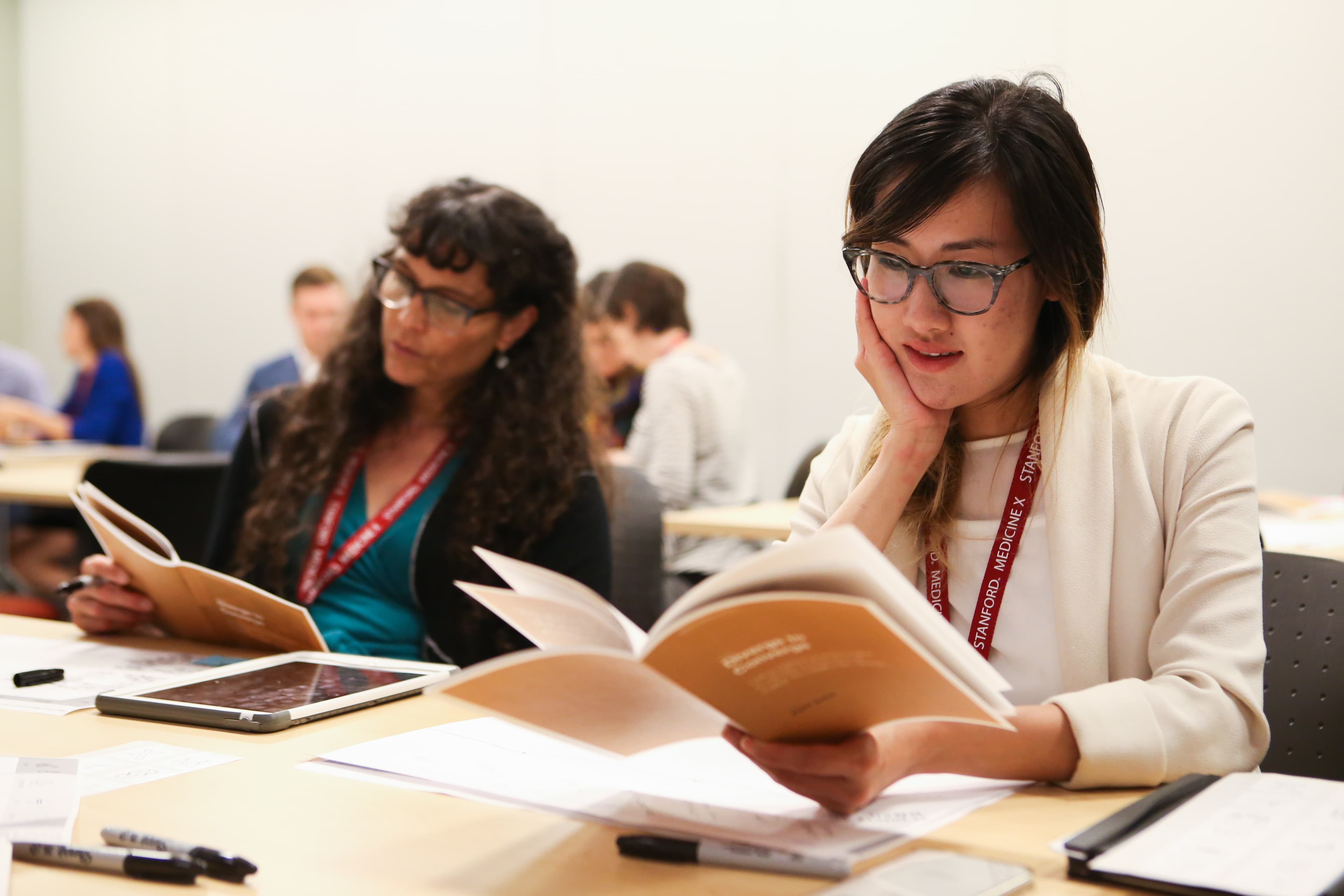 Workshop participants studying materials